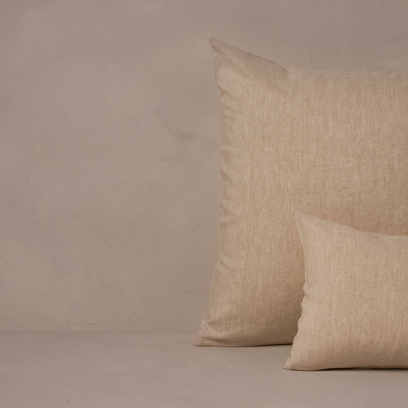 An image of a small boudoir or travel size pillow stacked in front of a large euro size pillow. The pillow cases are made in Italy of breathable and relaxed 100% linen, LETTO Classic Linen in color natural.