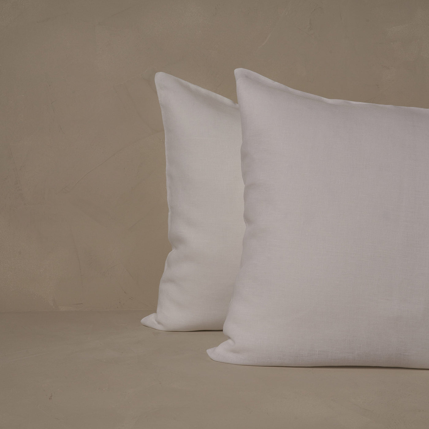 An image of two pillows stacked one in front of the other. The pillow cases are made of LETTO 100% linen Lino Primo in color white.