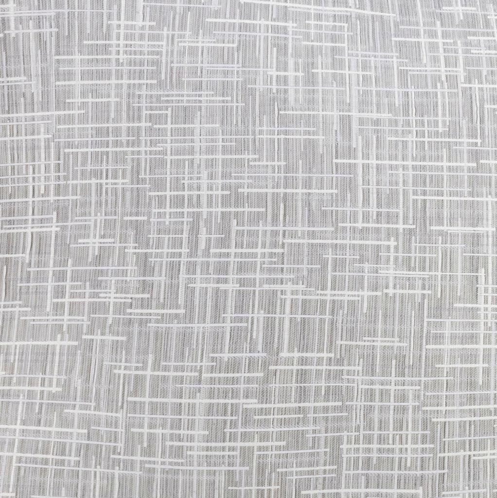 A close-up of LETTO’s Mosaico Jacquard Duvet Cover Clearance showcases its textured white surface, featuring intersecting lines in an irregular geometric pattern reminiscent of luxury woven shams.