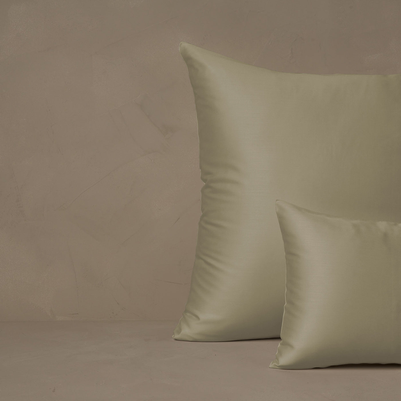 An image of a small boudoir or travel size pillow stacked in front of a large euro size pillow. The pillow cases are made in Italy of LETTO Woodland Silk fabric in color Pistachio, a smooth and silky beechwood modal.