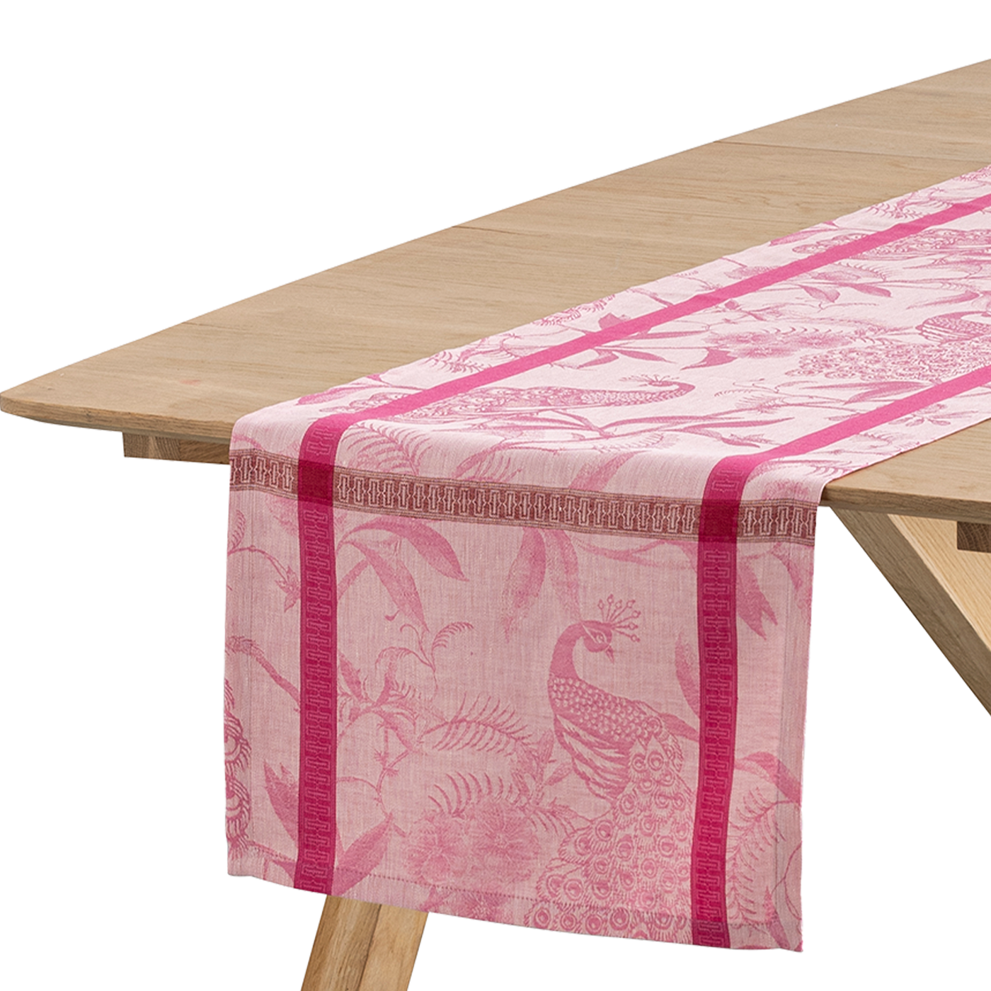 Le Jacquard Français À L'Orangerie table runner in rose with jacquard peacock and botanical pattern.