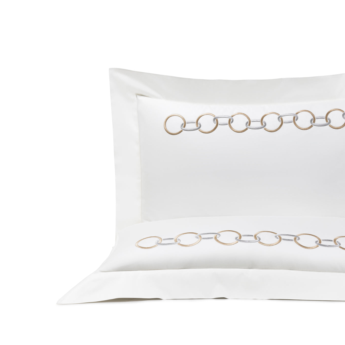 The Links Embroidered Sham by Frette features interlocking gold and silver chain links on white fabric, ideal for pairing with chain-embroidered bedding to enhance your luxury bedroom decor.