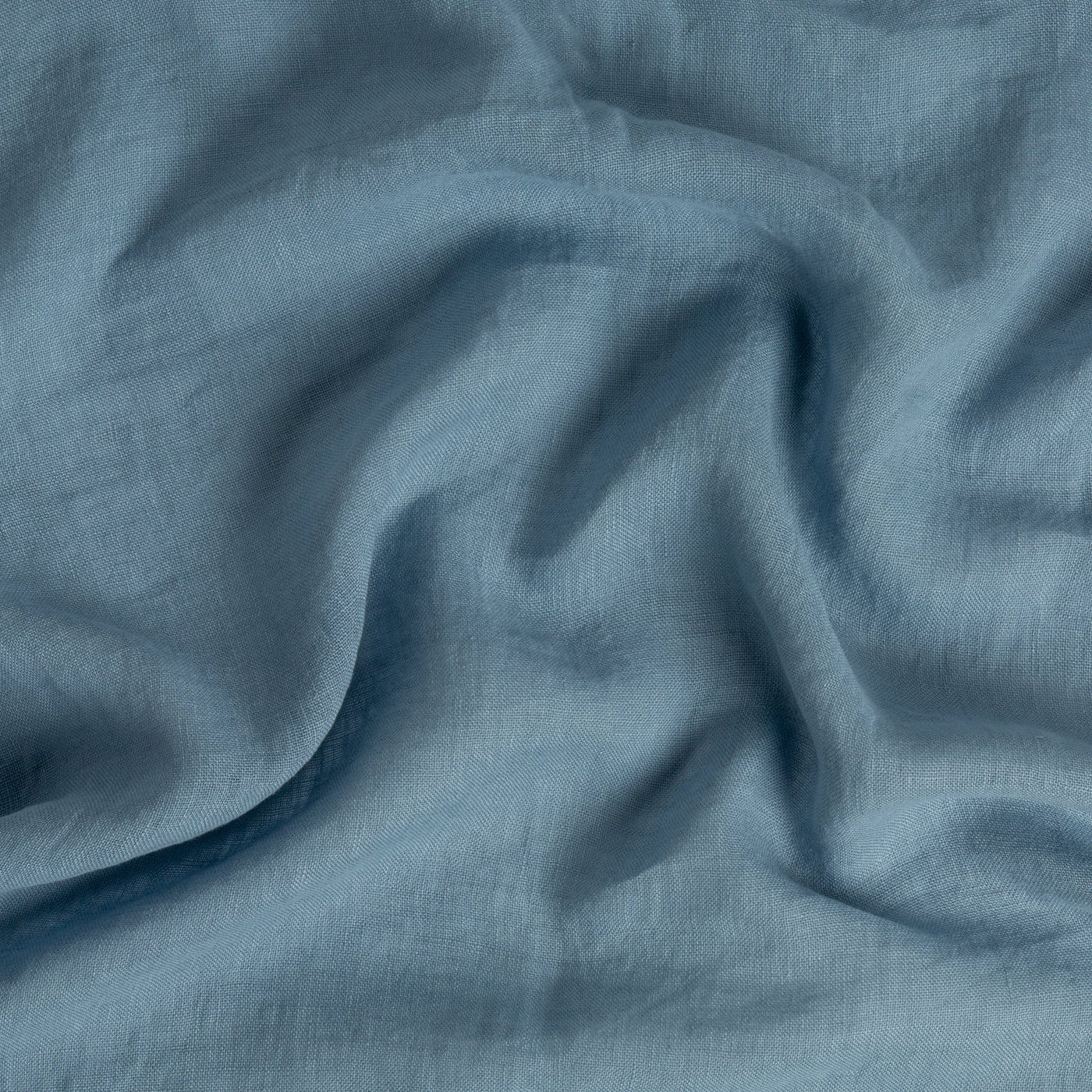 Close-up of Bella Notte Linen Whisper duvet cover in Tahoe Blue, showing softly draped linen fabric texture.