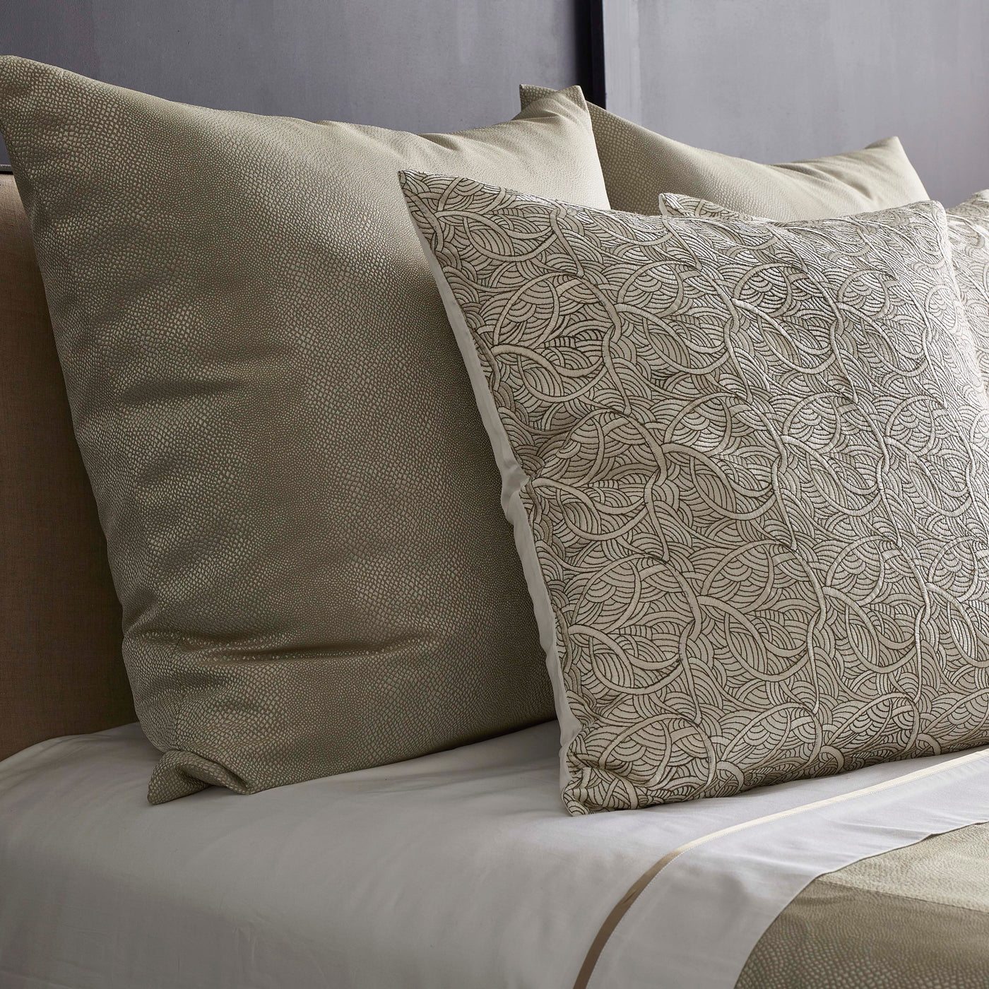 Close-up of Ann Gish La Sirene pillow with embroidered leaf pattern in champagne tones.