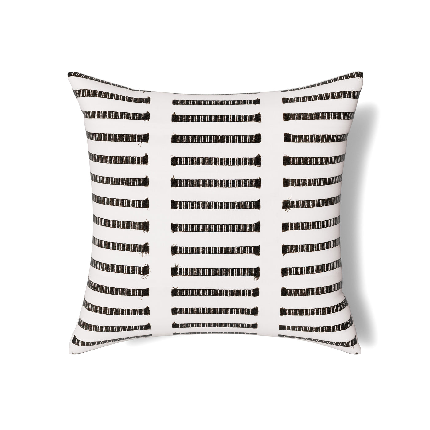 Close-up of Ann Gish Latera pillow with black dashed stripe pattern on ivory ground.
