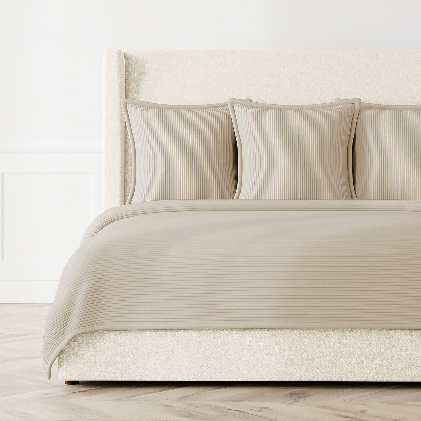 Taupe ribbed coverlet and matching shams styled on a bed, angled view showing full spread.