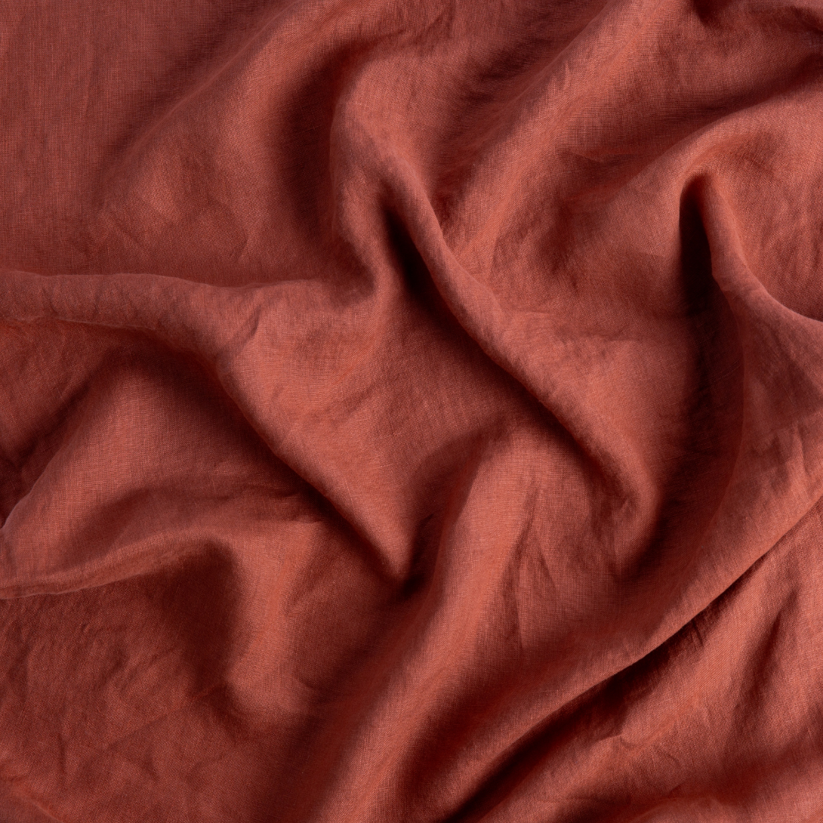 Close-up of Autumn linen fabric with soft draping and natural wrinkled texture.