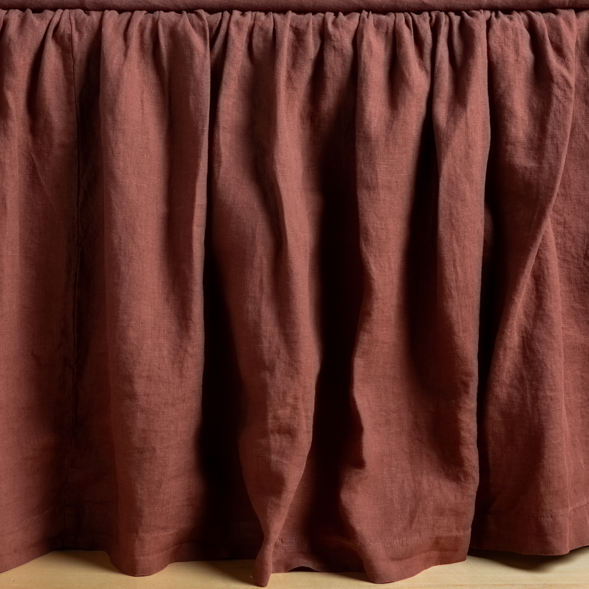 Bella Notte Linen bed skirt in Autumn, showing full gathered skirt drape to floor.
