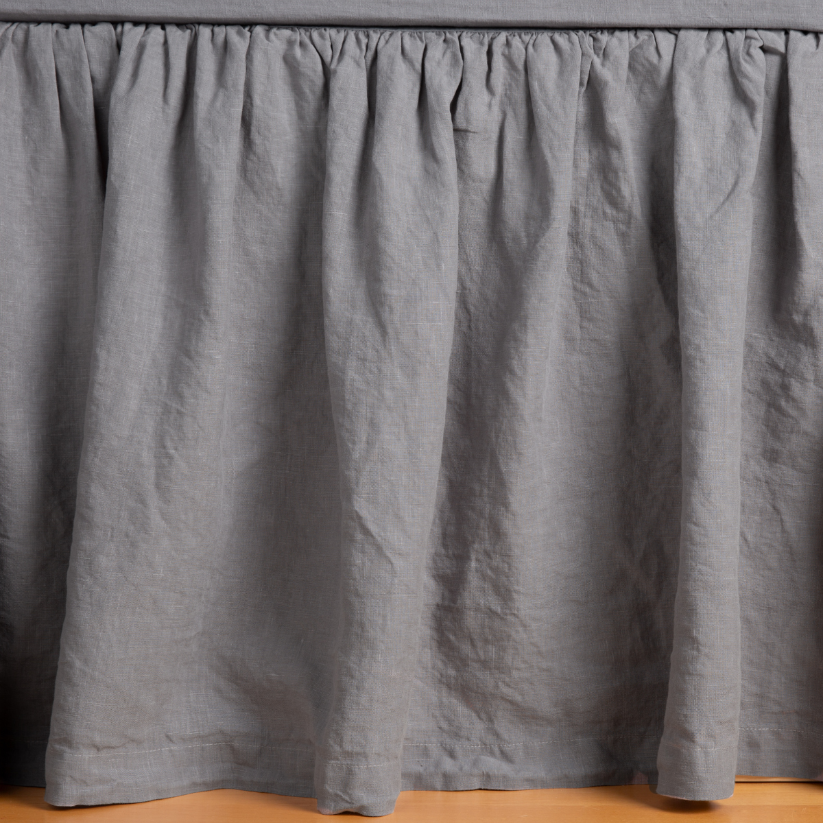 Gathered French Lavender linen bed skirt, full front view showing relaxed drape.