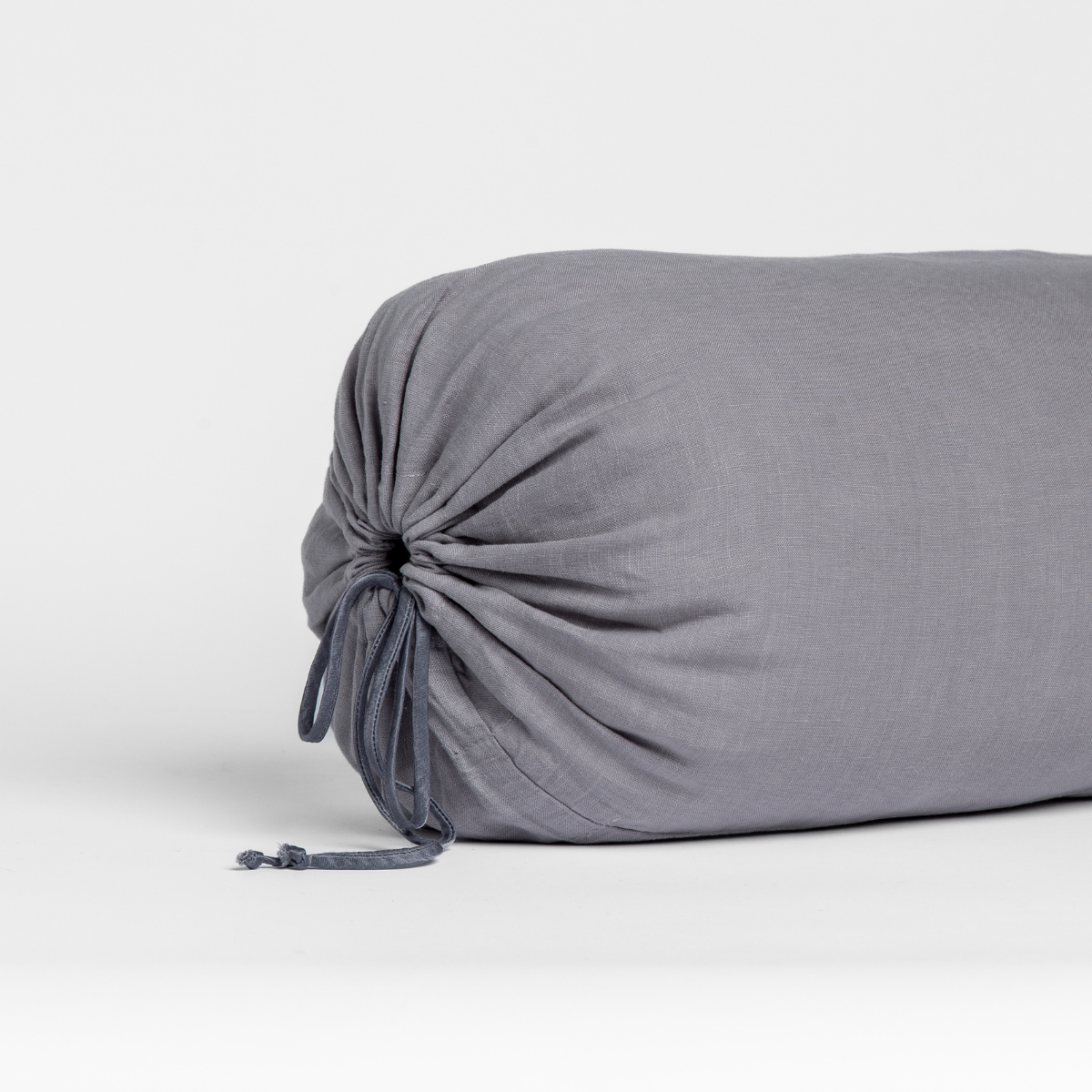 Close-up of gathered end tie detail on Bella Notte Linen throw pillow in French Lavender.