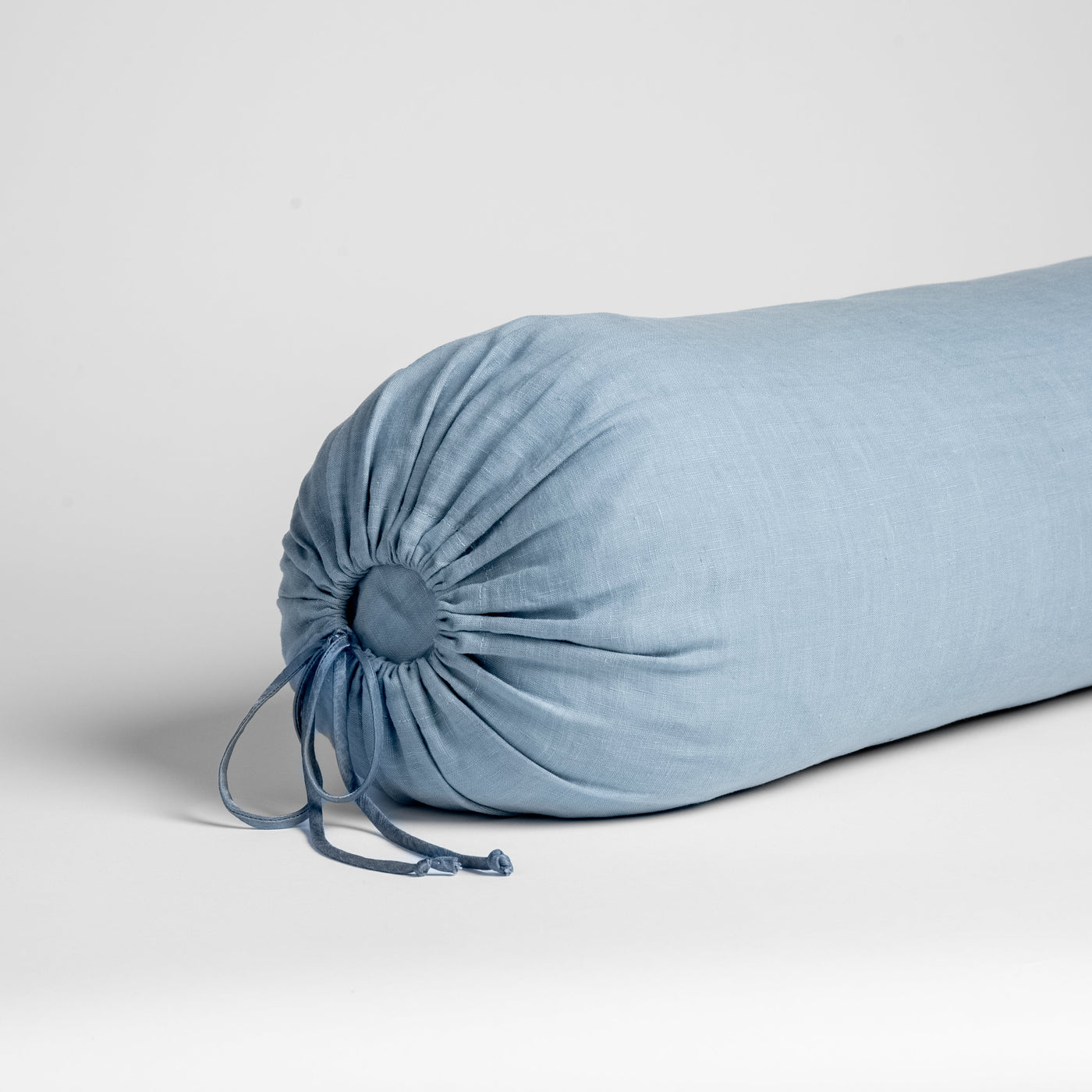 Close-up of Bella Notte Linen throw pillow end in Tahoe Blue, showing gathered drawstring detail.