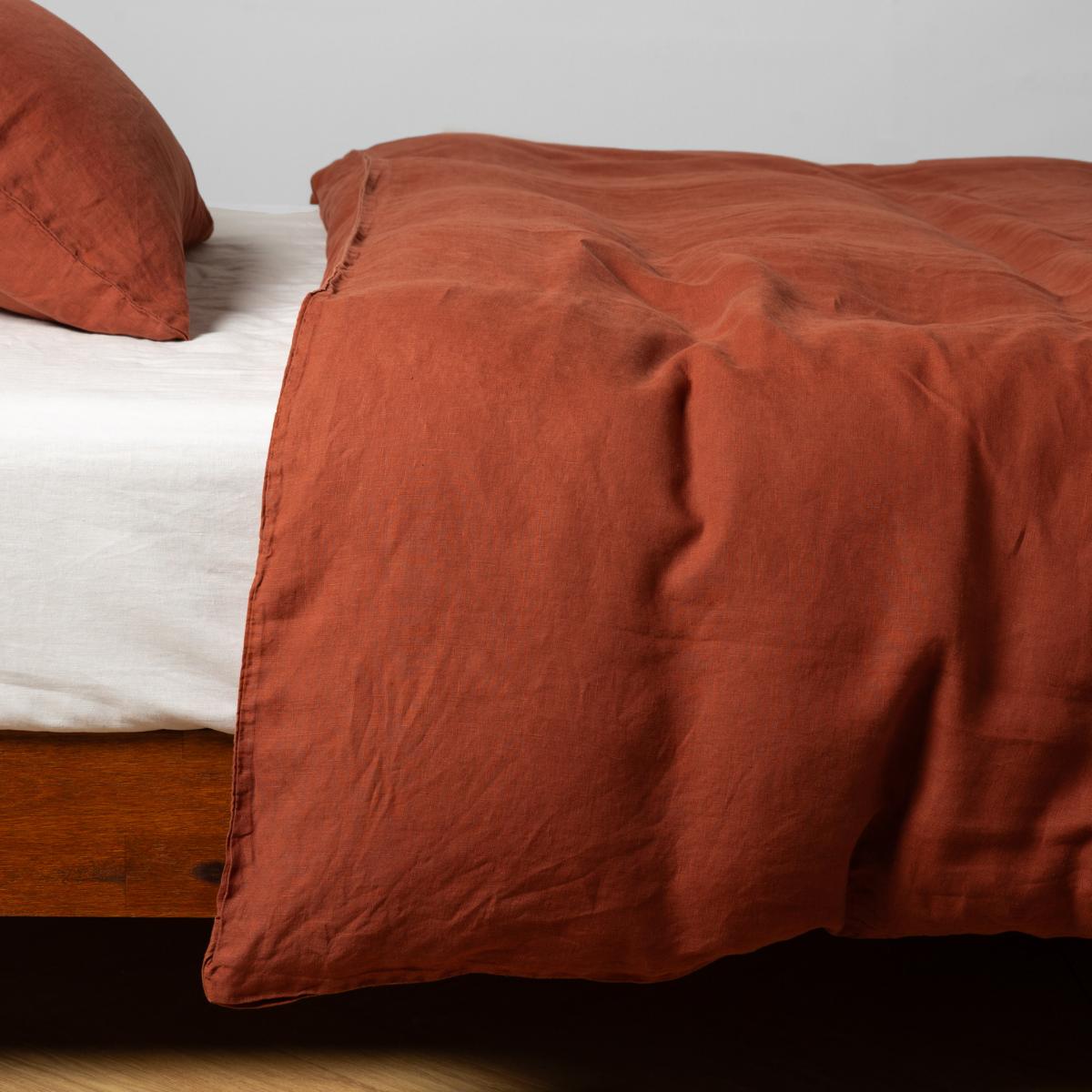 Bella Notte Linen duvet cover in Autumn, draped over bed showing relaxed texture.