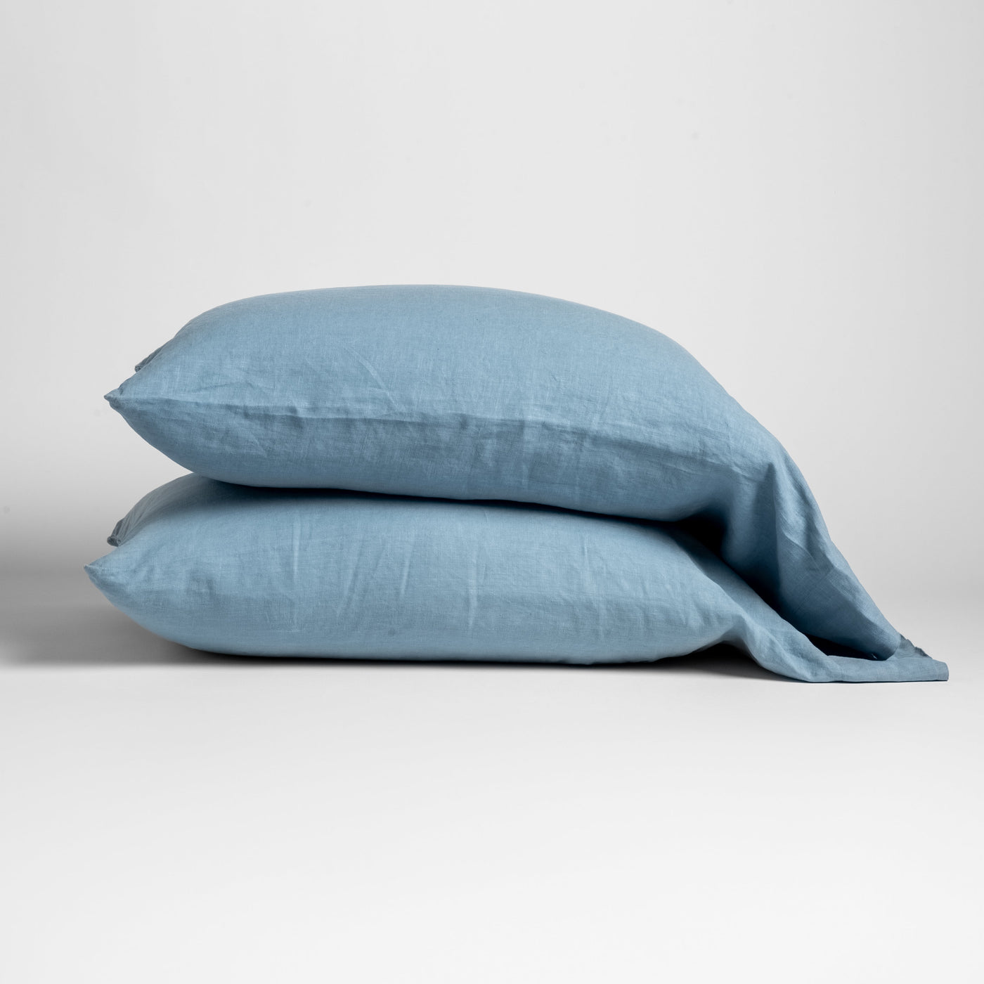 Tahoe Blue linen pillowcases stacked, showing relaxed texture and casual drape.