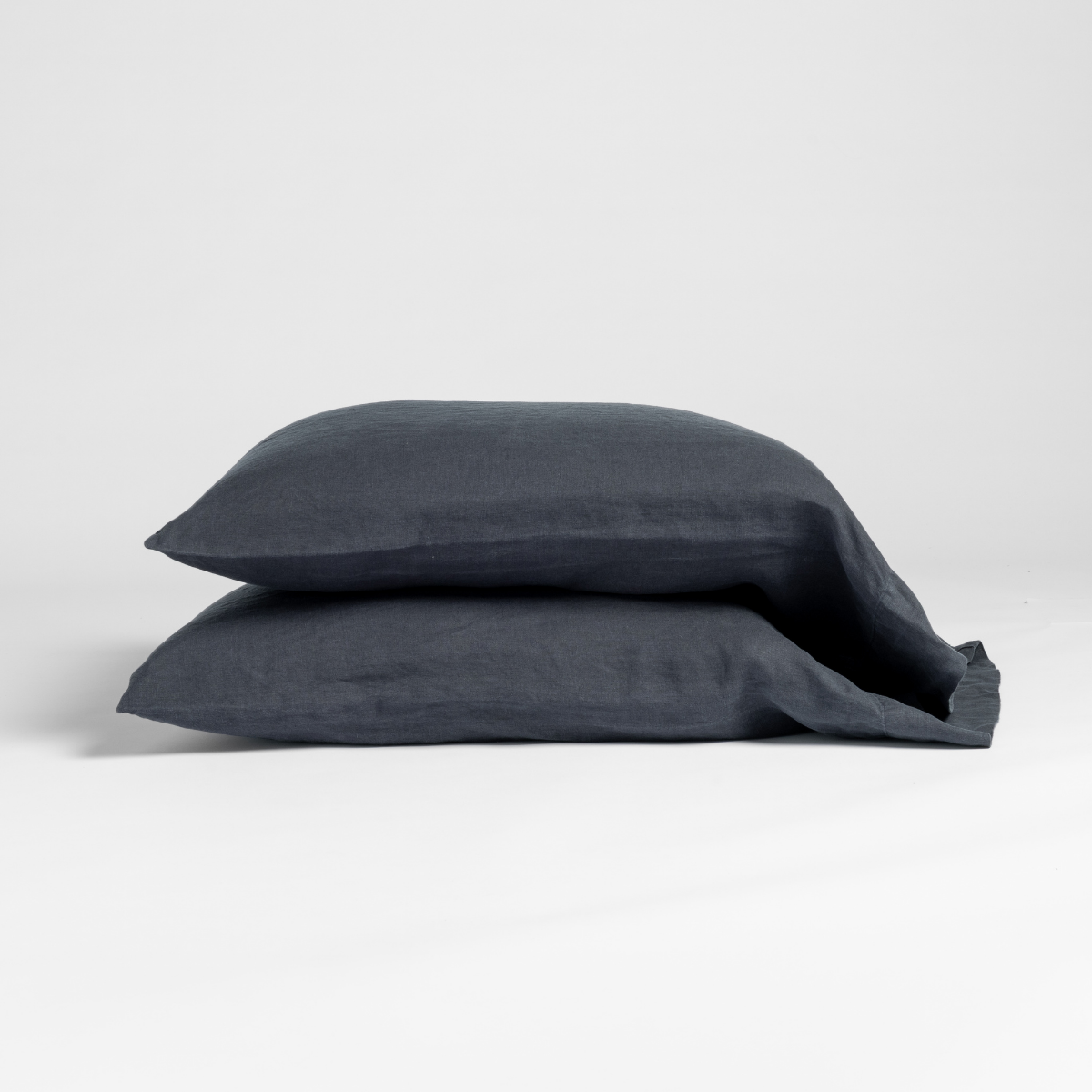 Two Bella Notte Linen pillowcases stacked in Slate, showing relaxed linen texture.