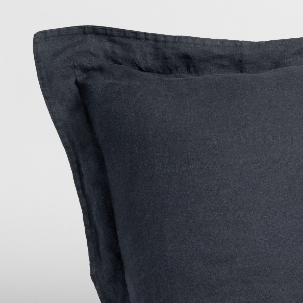 Close-up of Bella Notte Linen sham corner in Slate, showing flanged edge and woven texture.
