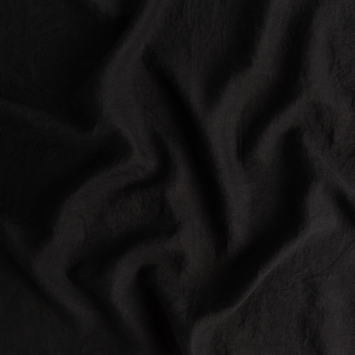 Close-up of Bella Notte Linen sham in Corvino, showing soft draped fabric texture.