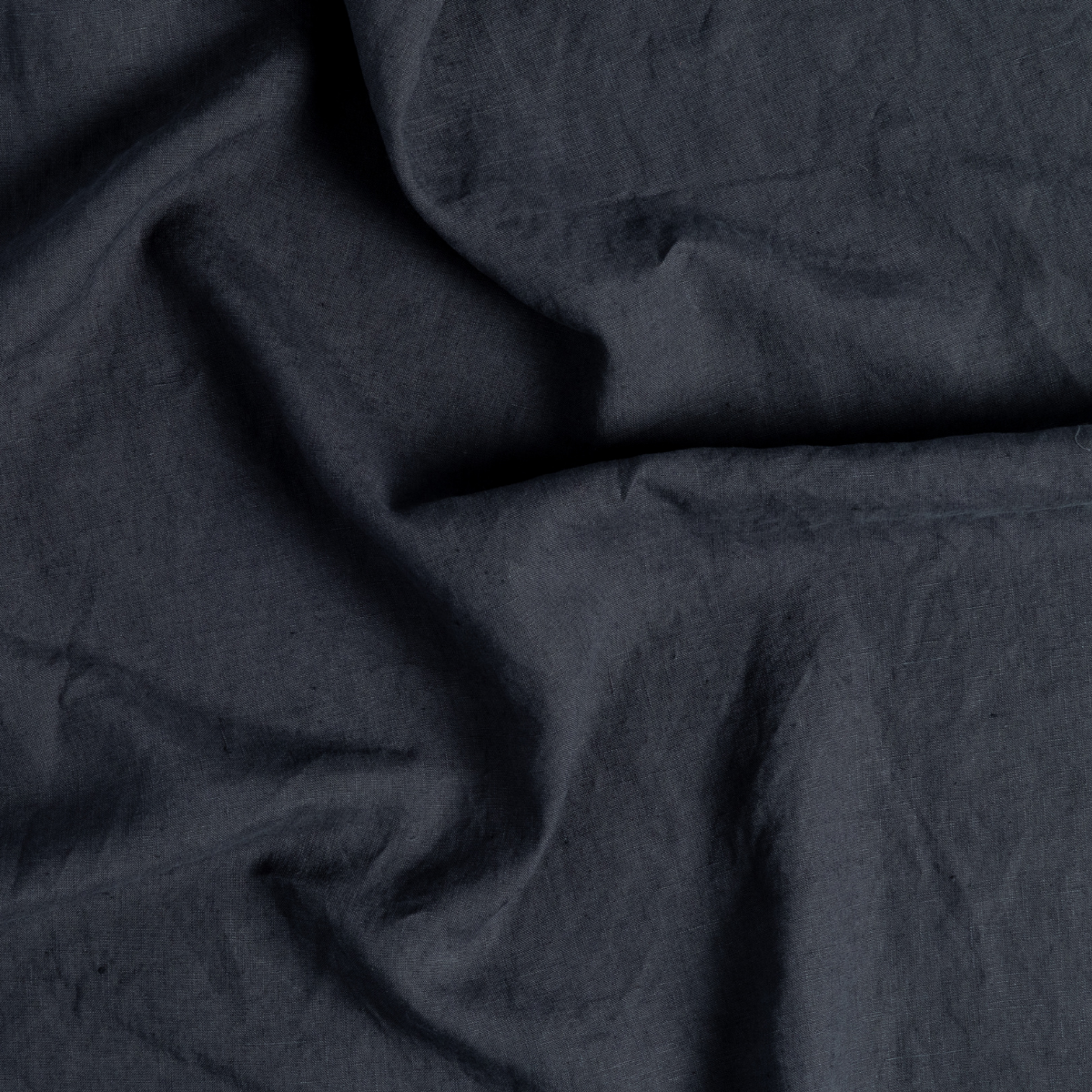 Close-up of Slate linen guest towel showing soft drape and natural wrinkled texture.