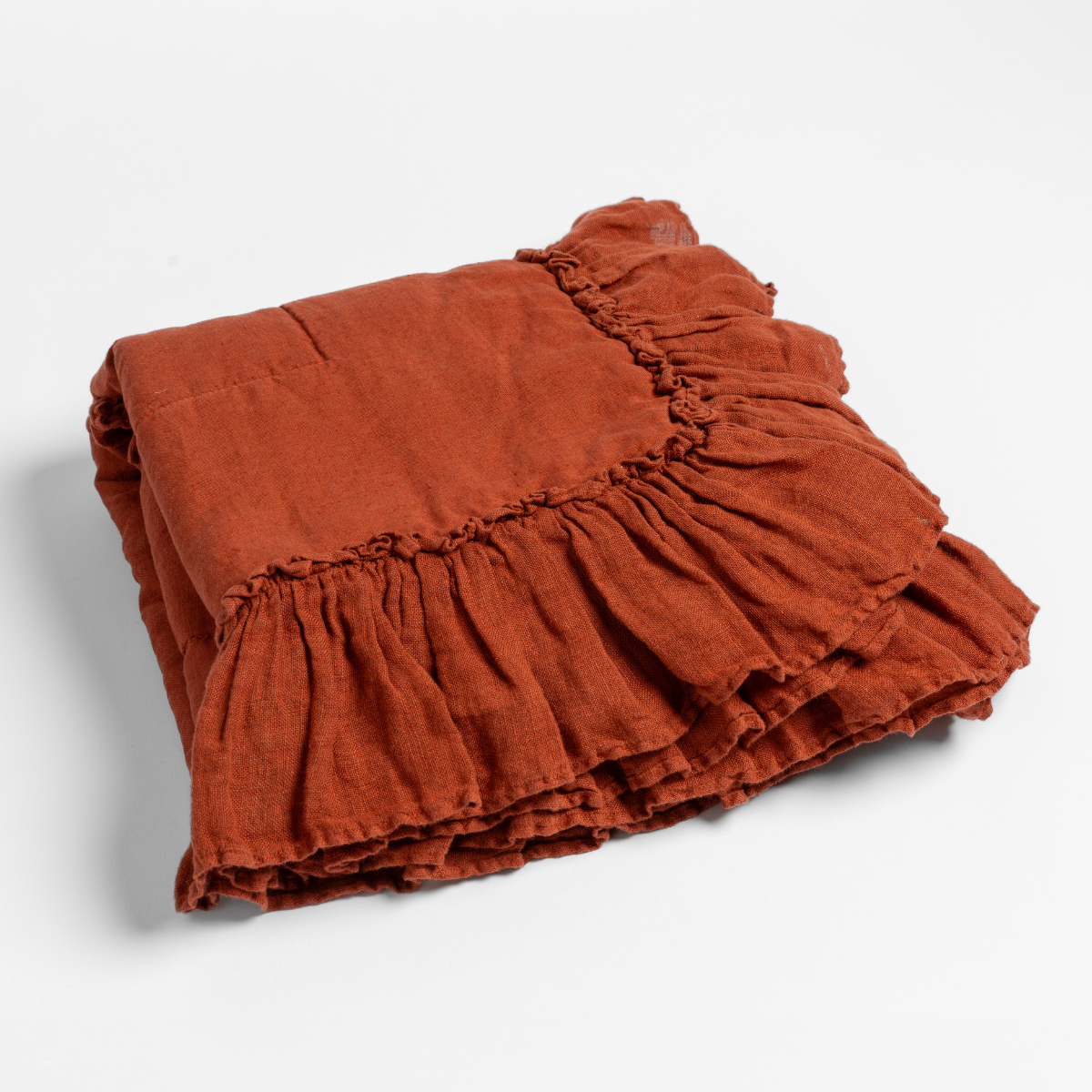 Bella Notte Linen Whisper baby blanket in Autumn, folded to show gathered ruffle trim detail.