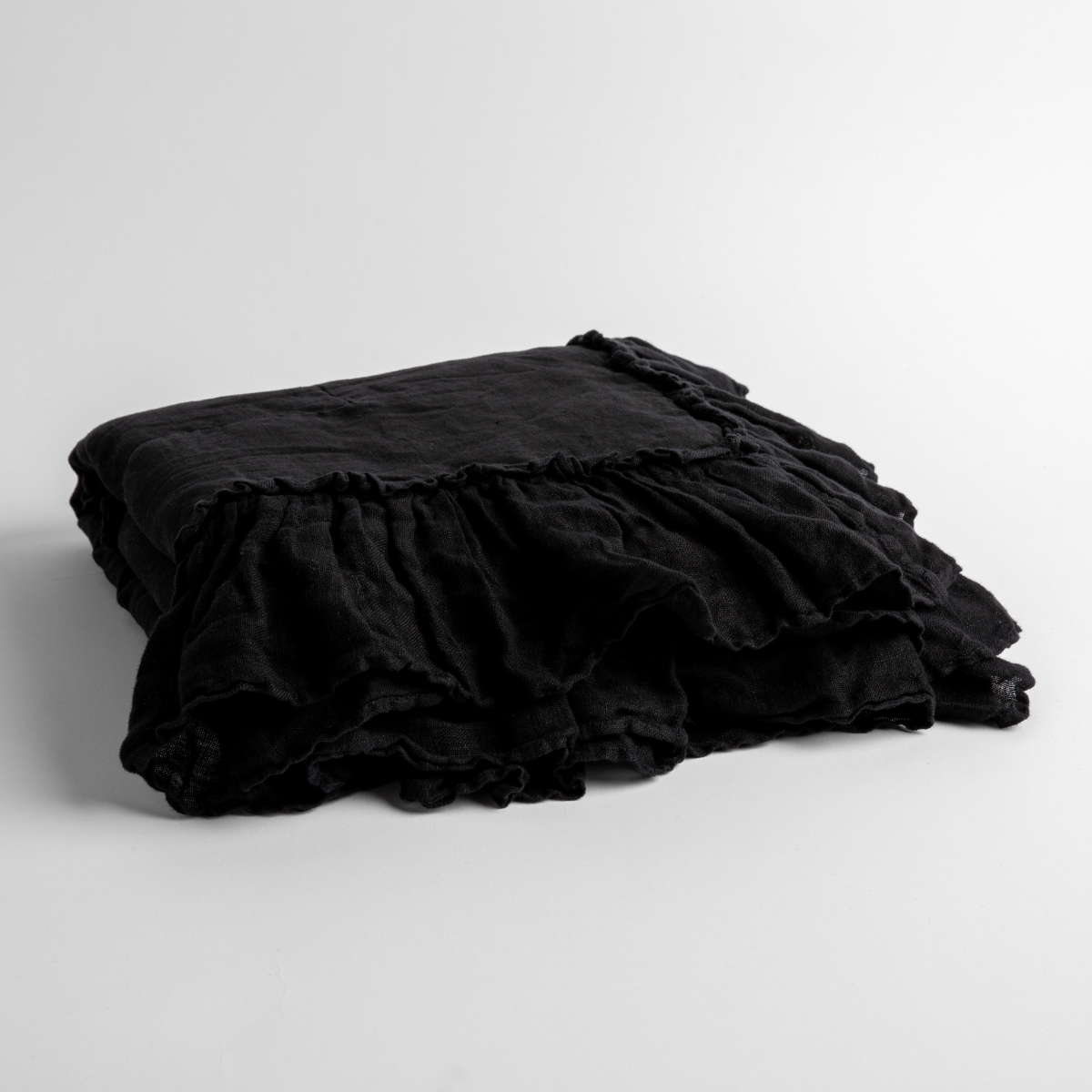 Ruffled edge detail on folded Corvino linen baby blanket.