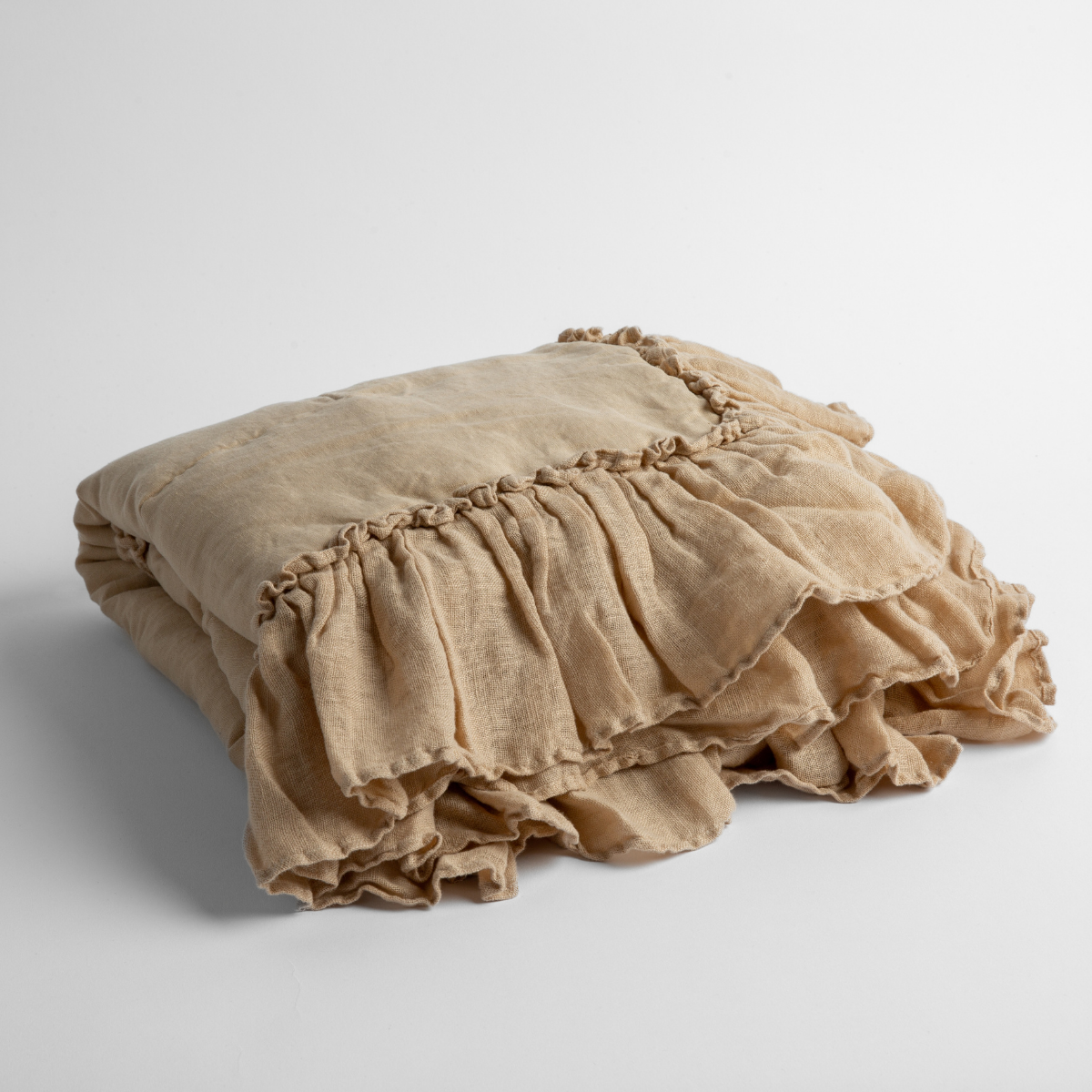 Bella Notte Linen Whisper baby blanket in Honeycomb, folded showing ruffled trim detail.