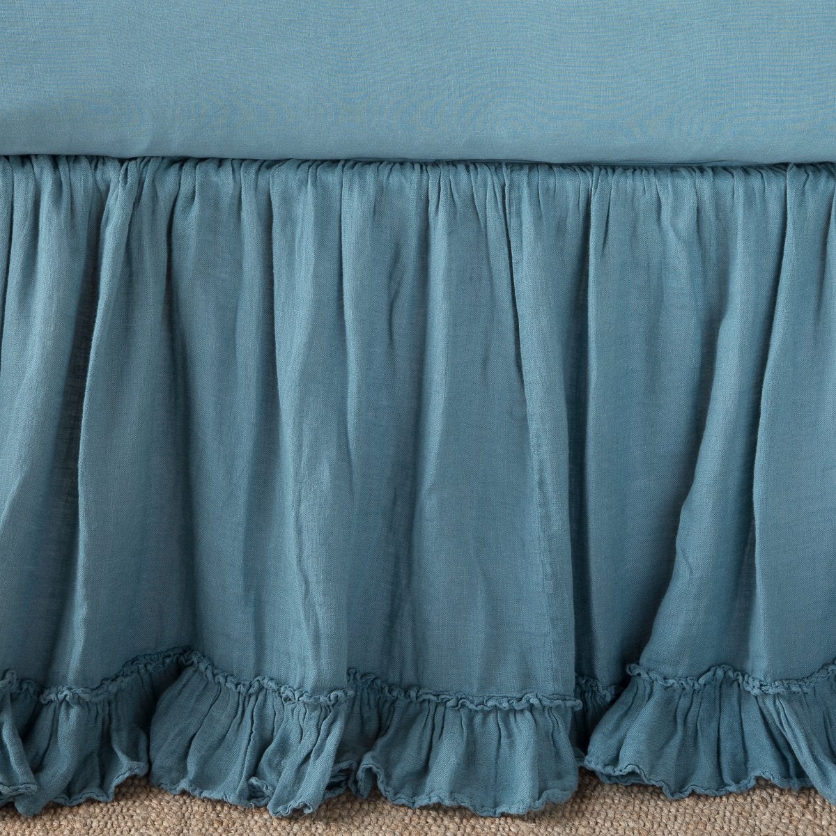 Ruffled Cenote linen bed skirt hem detail with double-tiered ruffle trim.