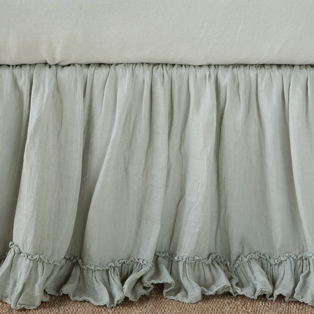Gathered eucalyptus linen bed skirt with ruffled hem detail, floor-length drop.