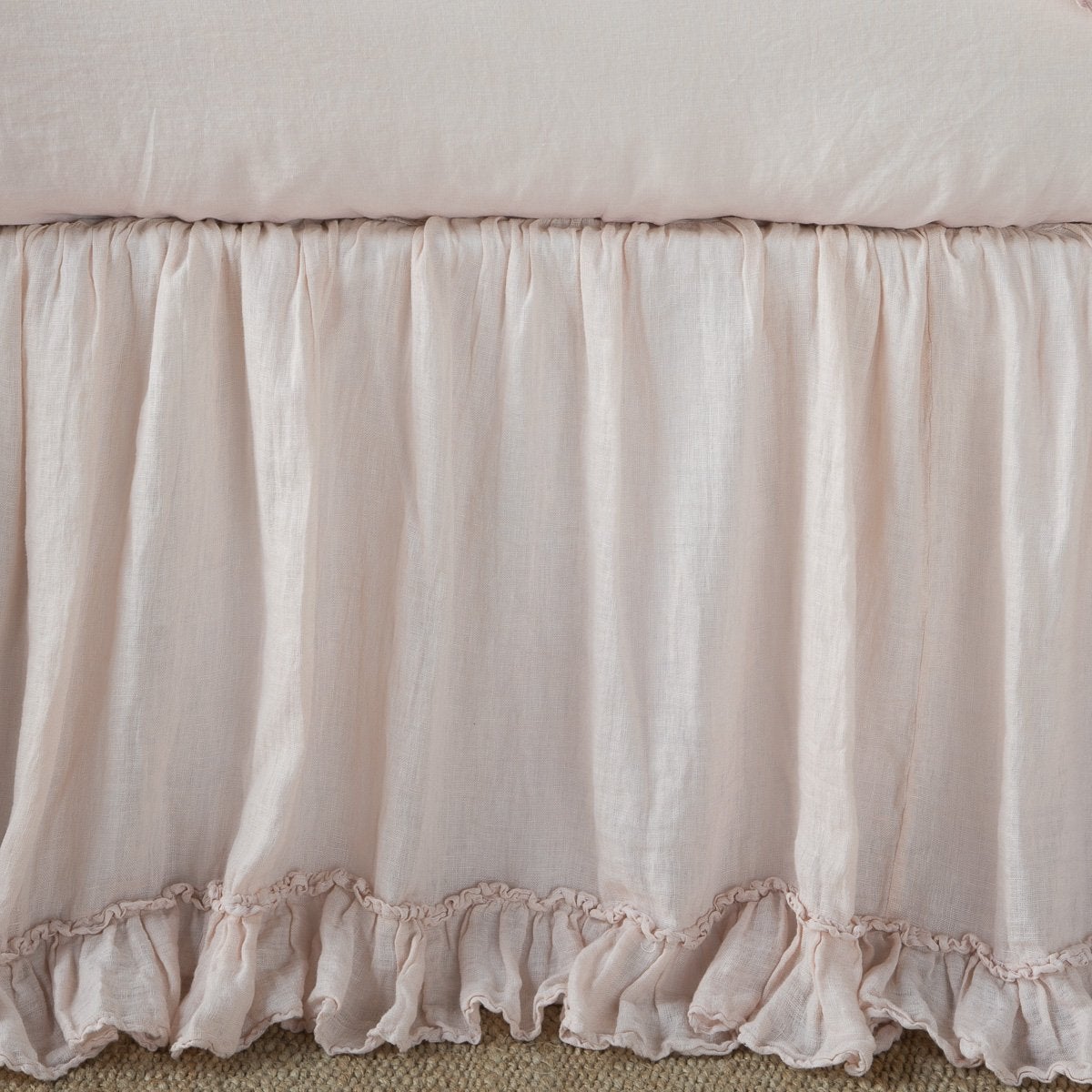 Gathered Pearl linen bed skirt with delicate ruffle hem trim, close-up front view.