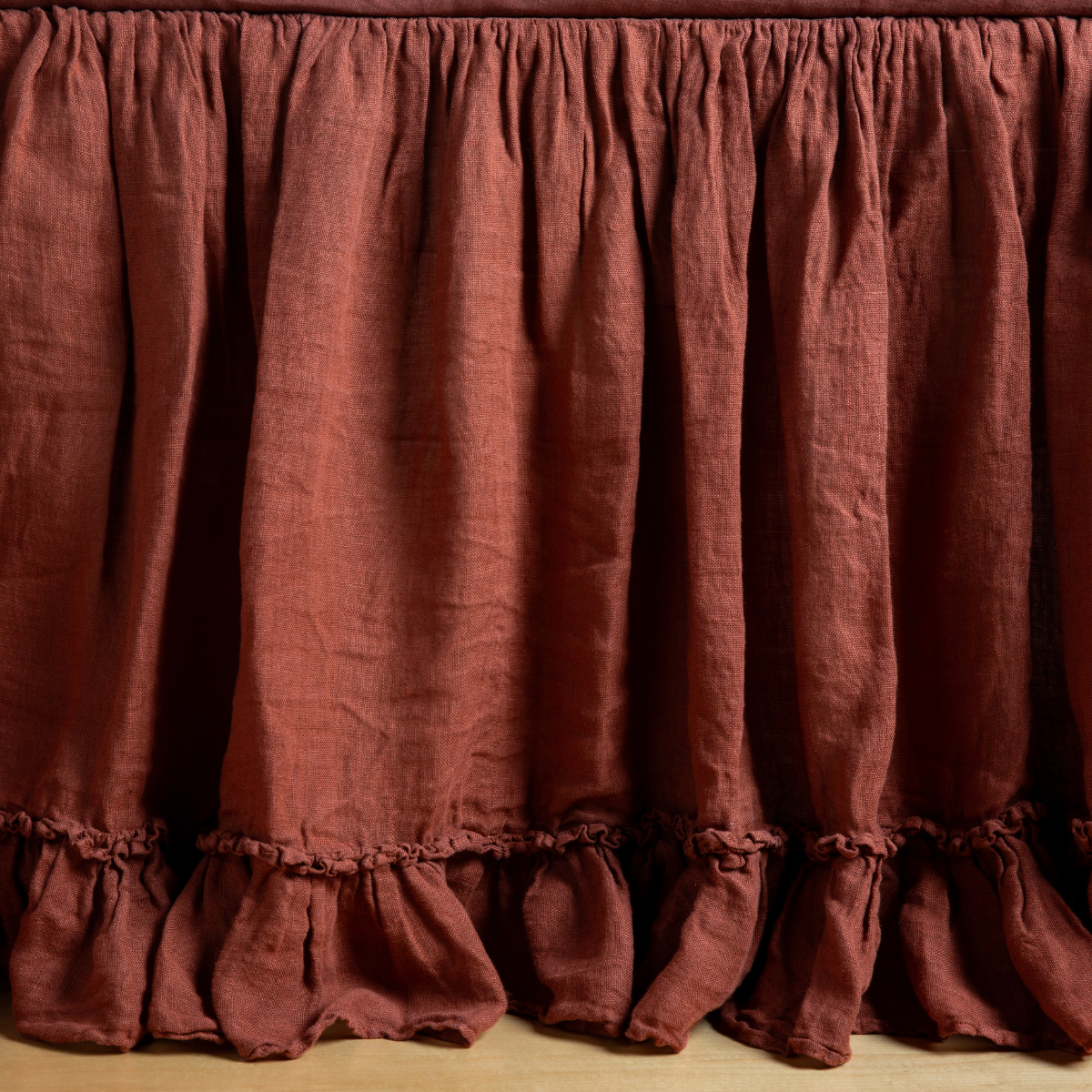 Close-up of Bella Notte Linen Whisper crib skirt in Autumn, showing gathered ruffle hem detail.