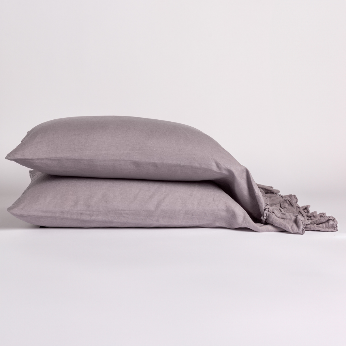 Two French Lavender Bella Notte Linen Whisper pillowcases stacked with ruffled edge detail visible.