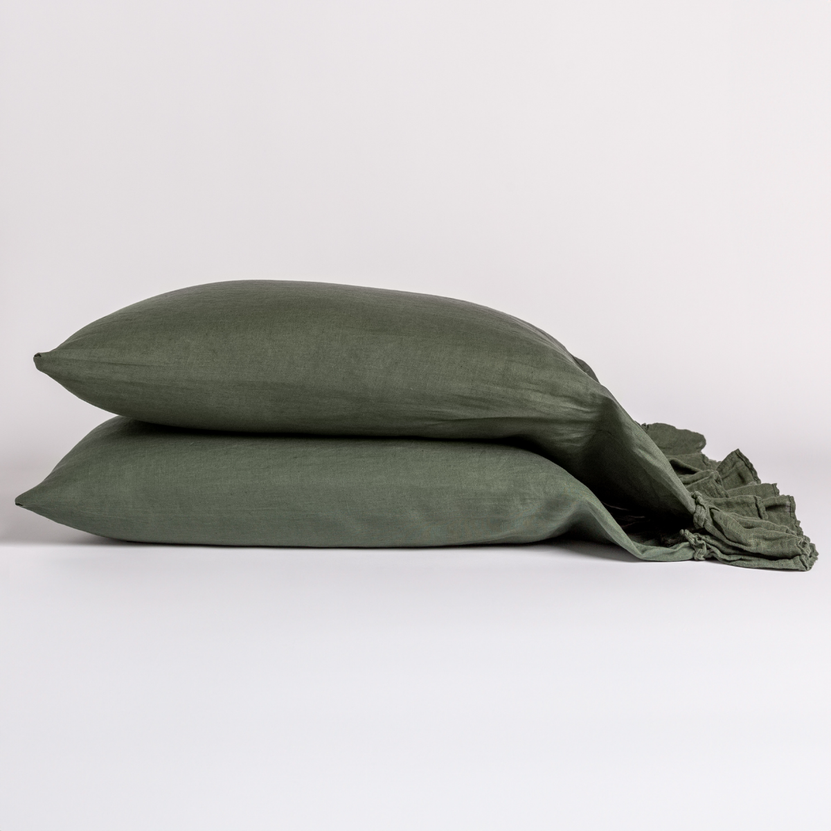 Two Juniper Bella Notte Linen Whisper pillowcases stacked, with tied ribbon closure detail.