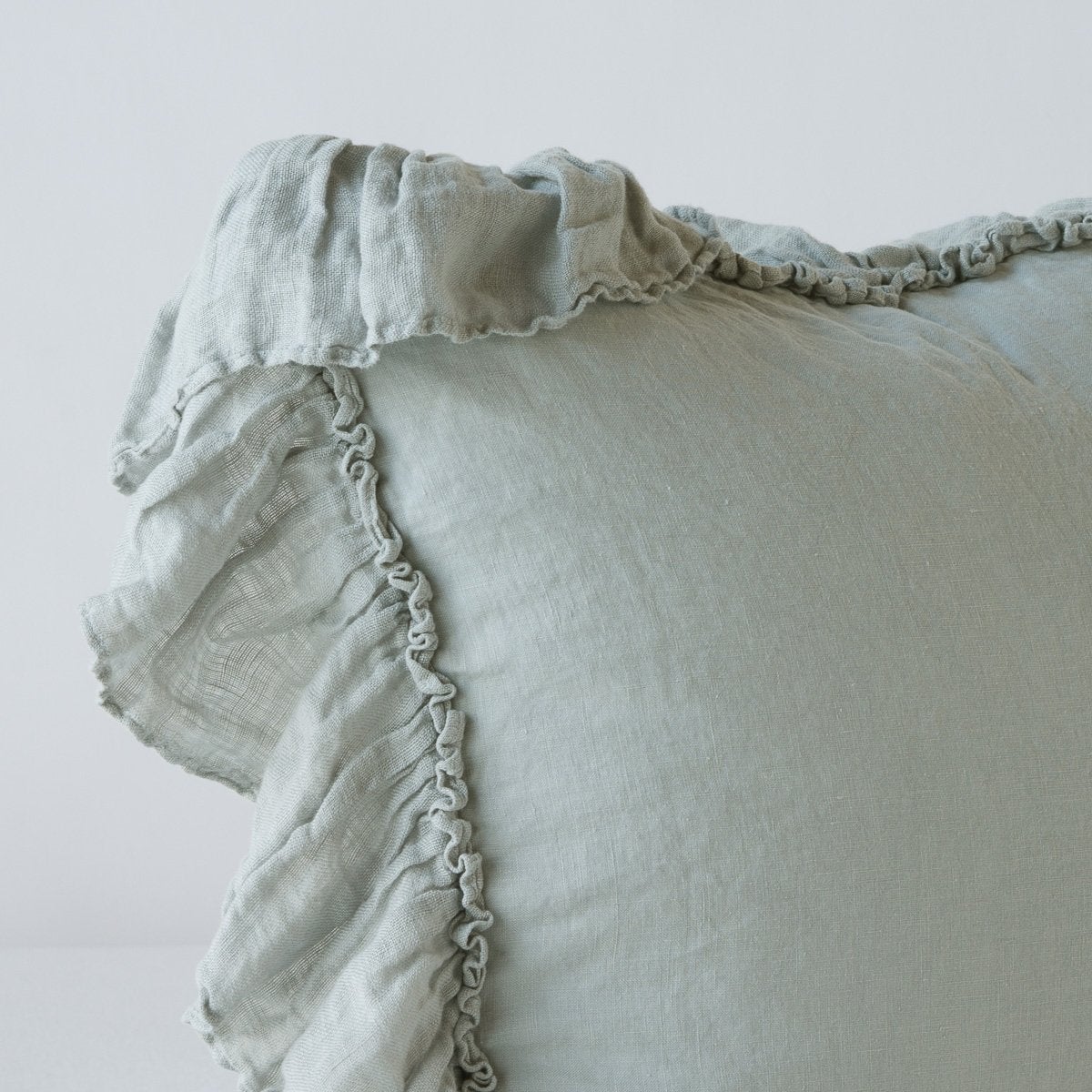 Close-up of ruffled edge detail on Bella Notte Linen Whisper sham in Eucalyptus.