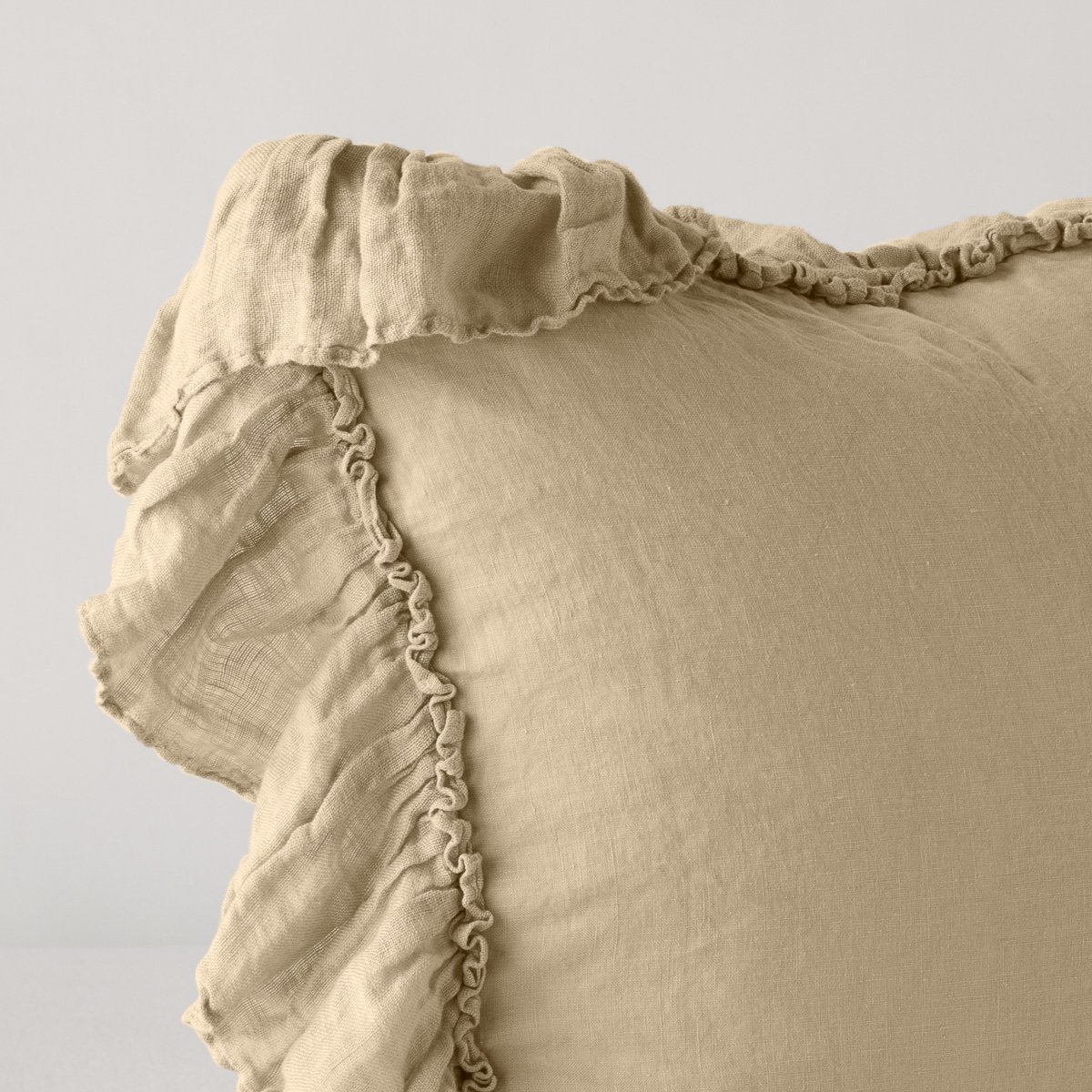 Close-up of Honeycomb linen sham corner with ruffled trim detail.