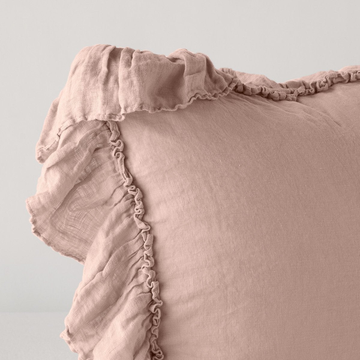 Close-up of Bella Notte Linen Whisper sham corner, showing ruffled trim detail in dusty rose linen.