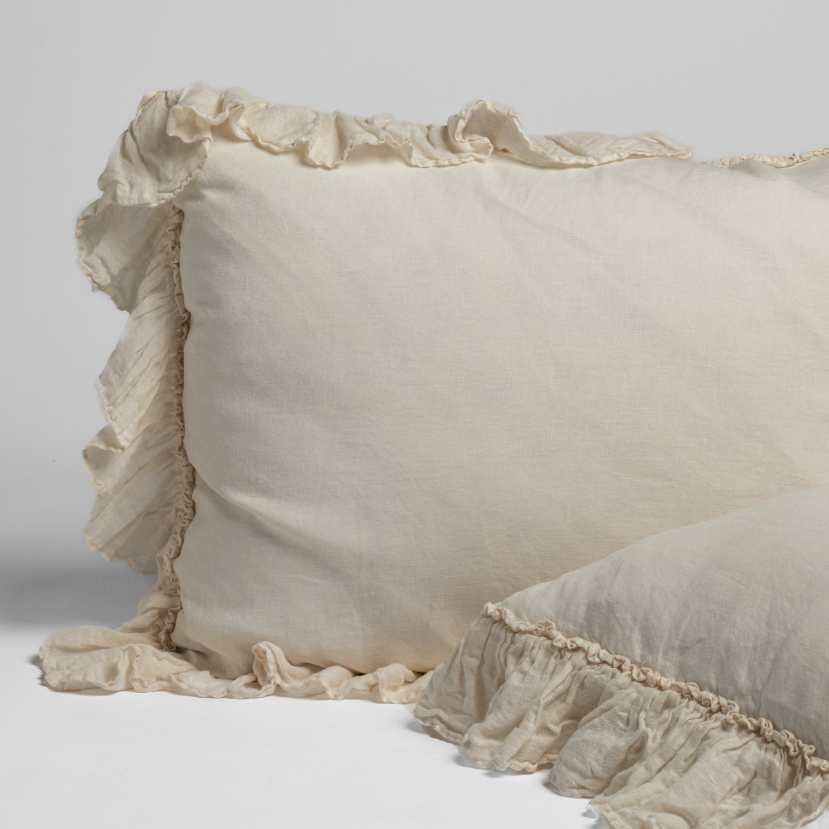 Close-up of Bella Notte Linen Whisper sham in Natural with ruffled trim detail.
