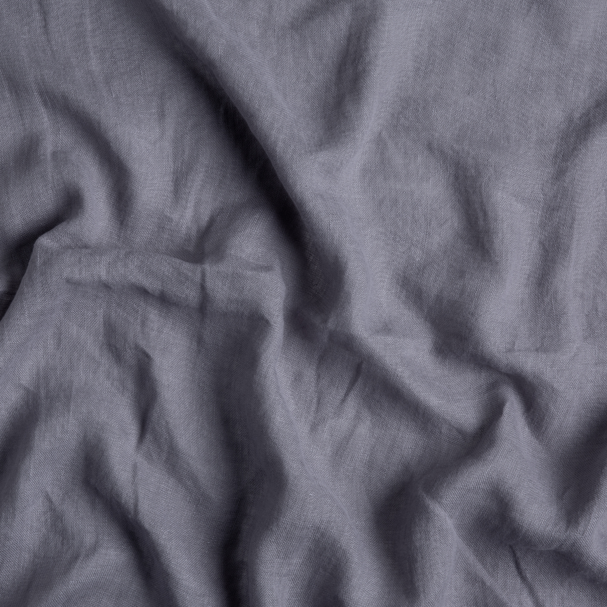 Close-up of French Lavender linen fabric with soft, relaxed draping and natural creases.