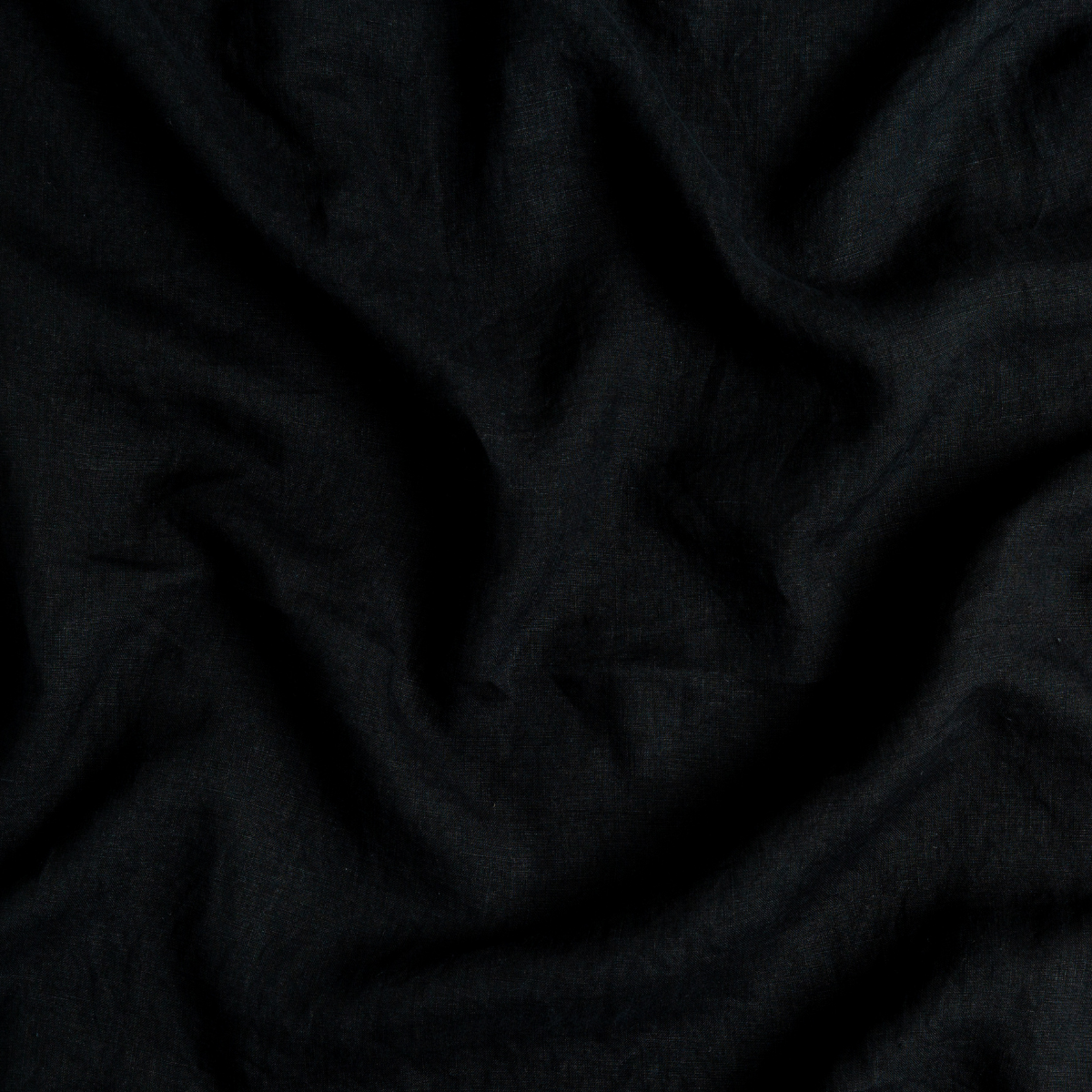 Draped Corvino linen pillowcase fabric showing soft folds and natural texture.