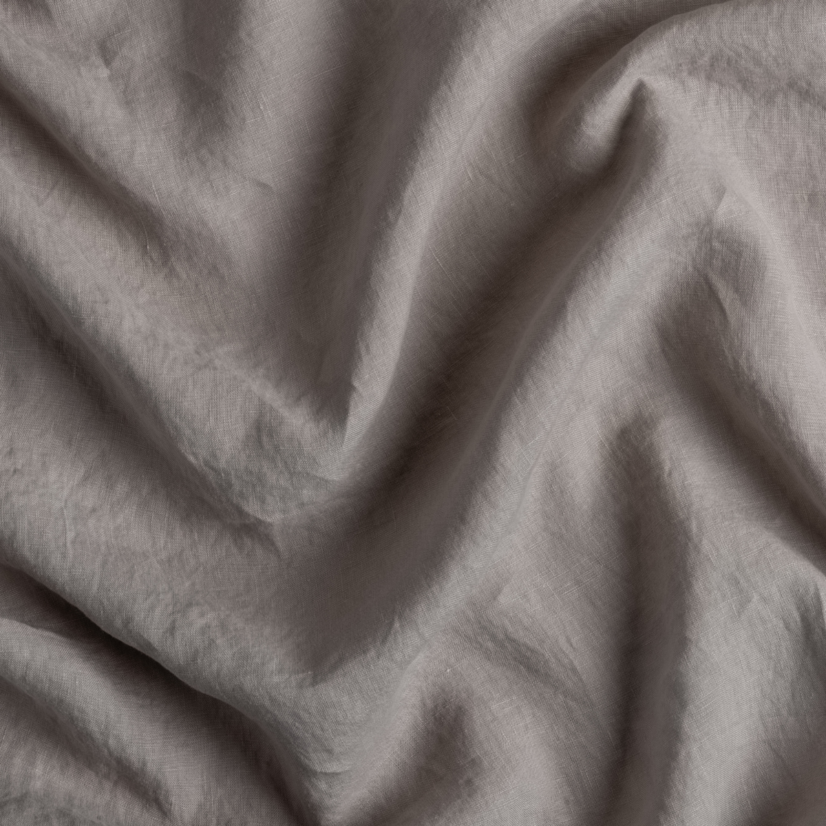 Close-up of Fog linen pillowcase fabric showing soft drape and natural texture.