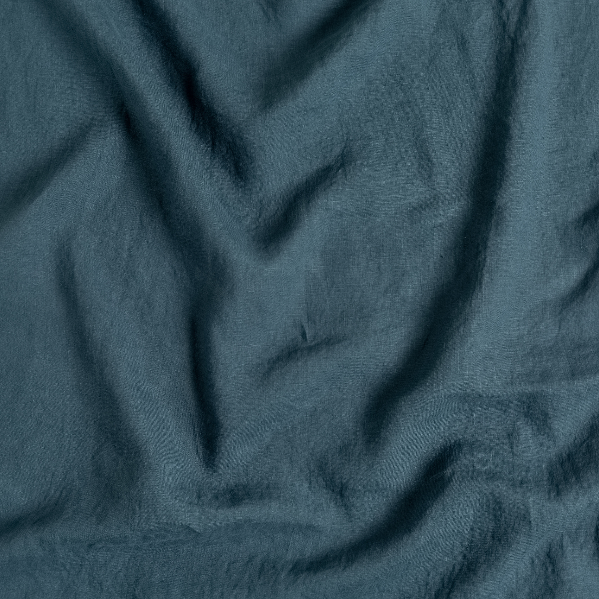 Close-up of Midnight linen fabric showing soft drape and natural wrinkled texture.