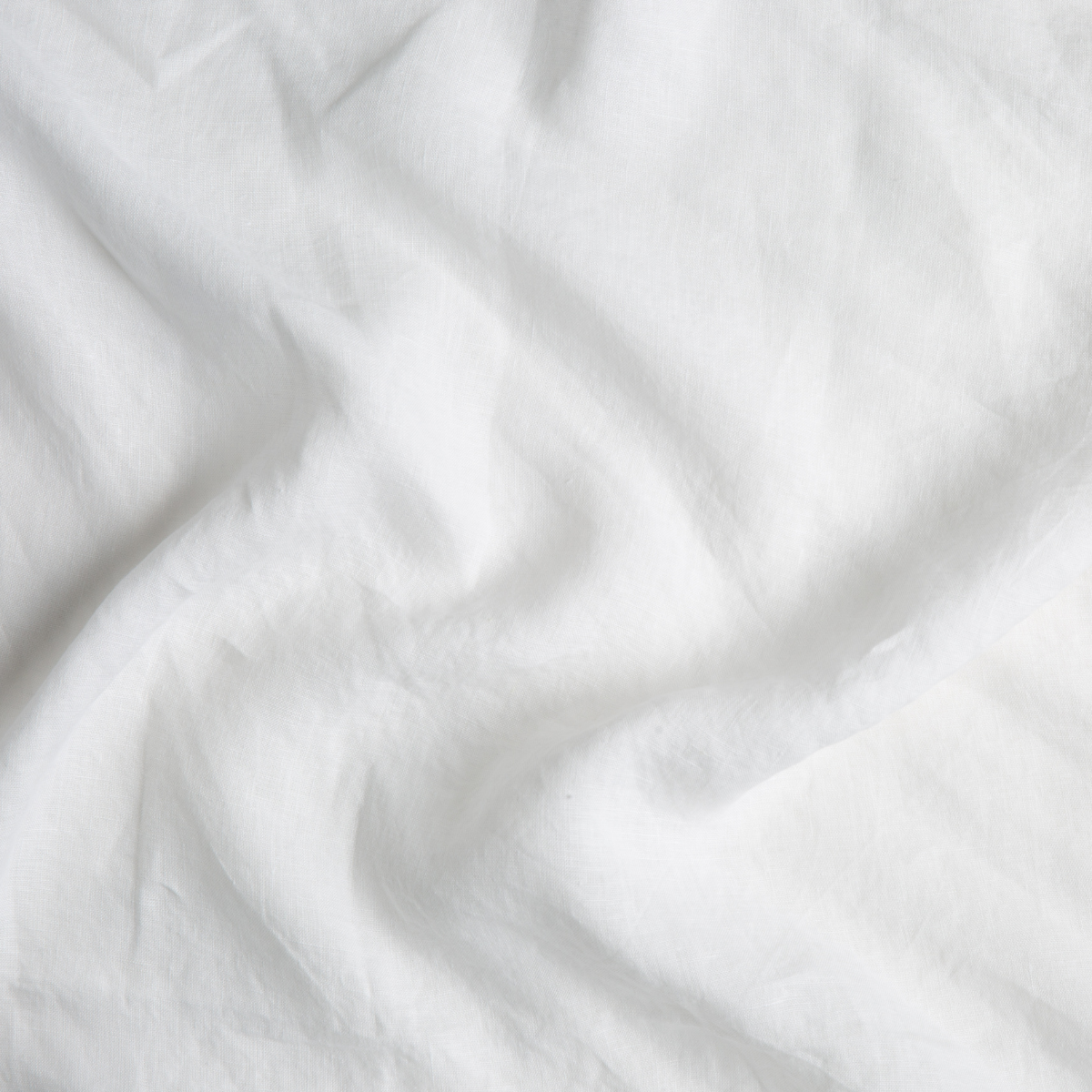 Close-up of Winter White linen fabric with soft natural drape and texture.