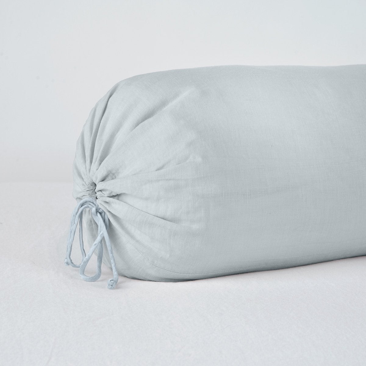 Bella Notte Cloud linen bolster throw pillow with gathered tie end detail.