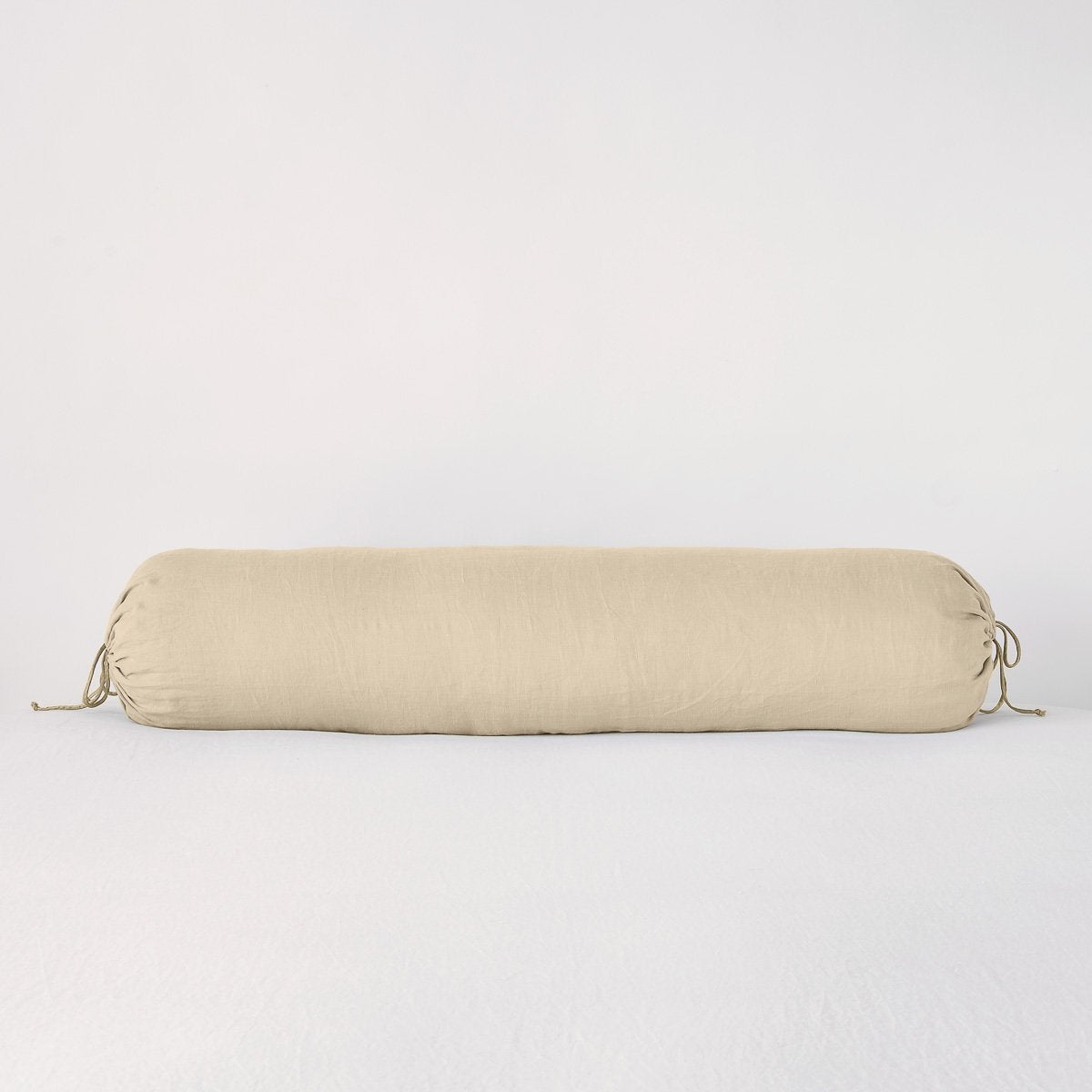 Bella Notte Linen bolster throw pillow in Honeycomb with gathered tie ends.