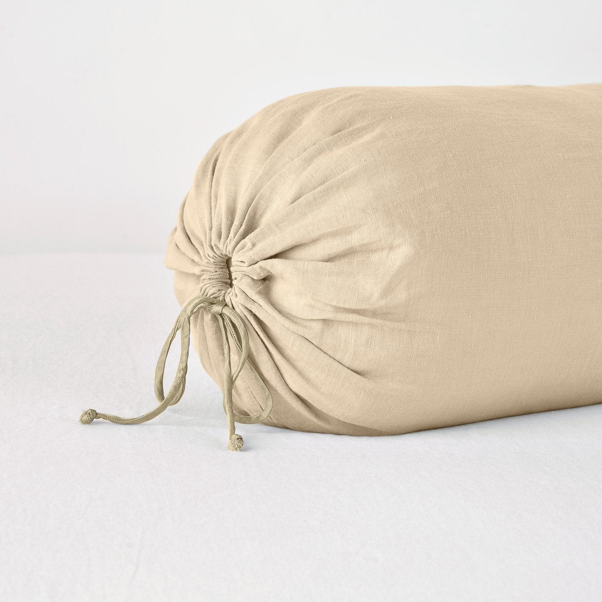 Close-up of Bella Notte Linen throw pillow end in Honeycomb with gathered drawstring detail.