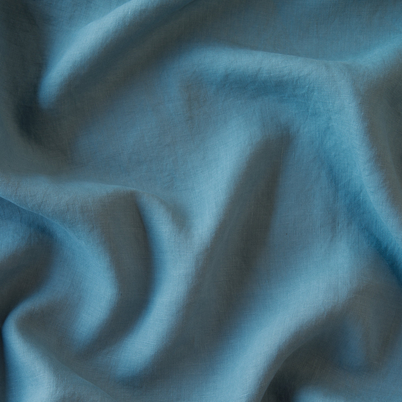 Close-up of Bella Notte Linen sham fabric in Cenote, showing draped woven texture.