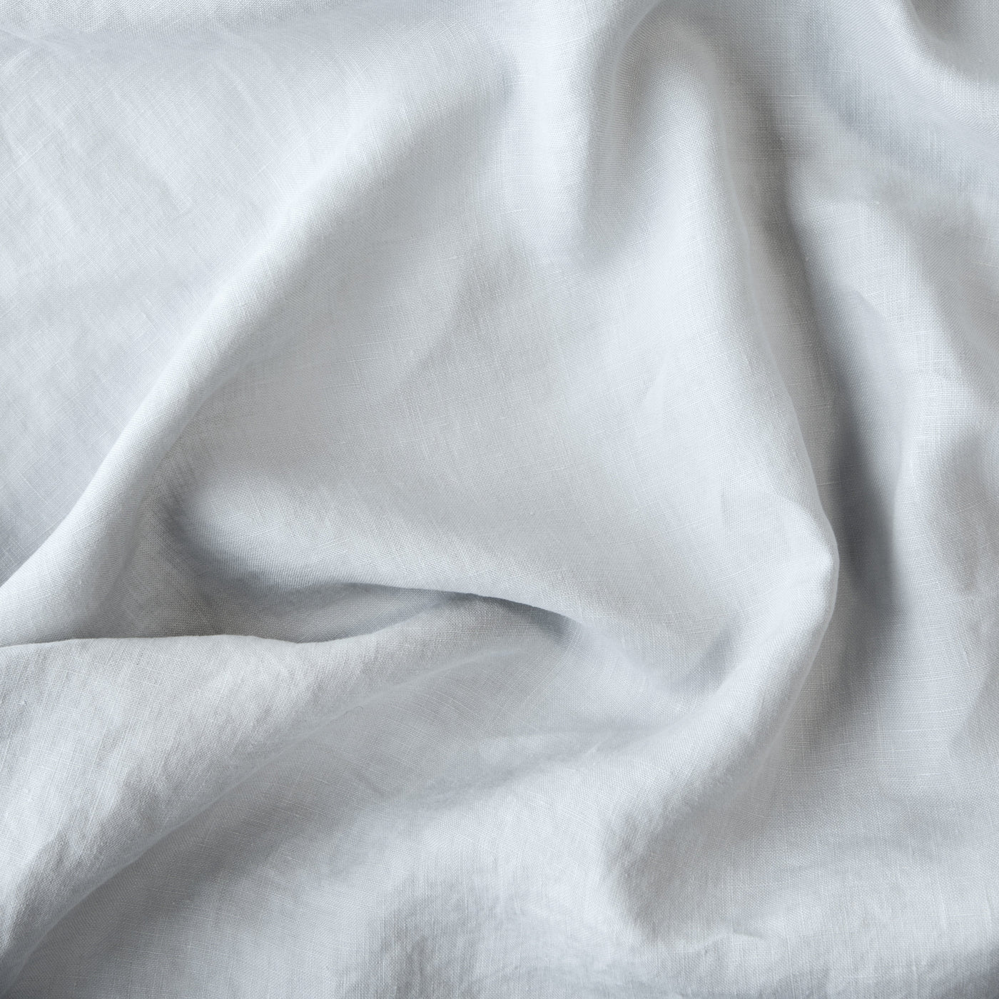 Close-up of Cloud Bella Notte linen sham fabric showing soft drape and relaxed texture.