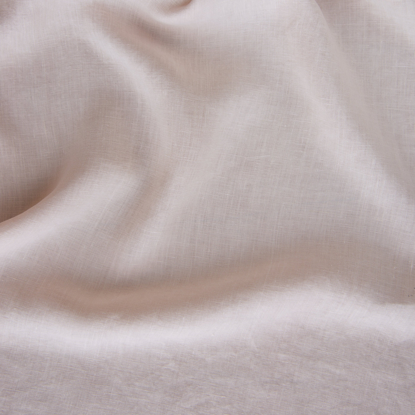 Close-up of draped Pearl linen fabric with soft folds and a fine woven texture.