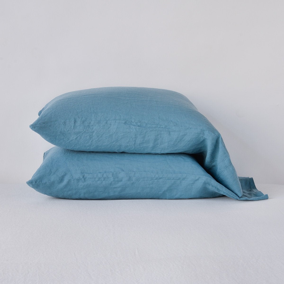 Two Bella Notte Linen pillowcases stacked in Cenote, showing relaxed natural texture.