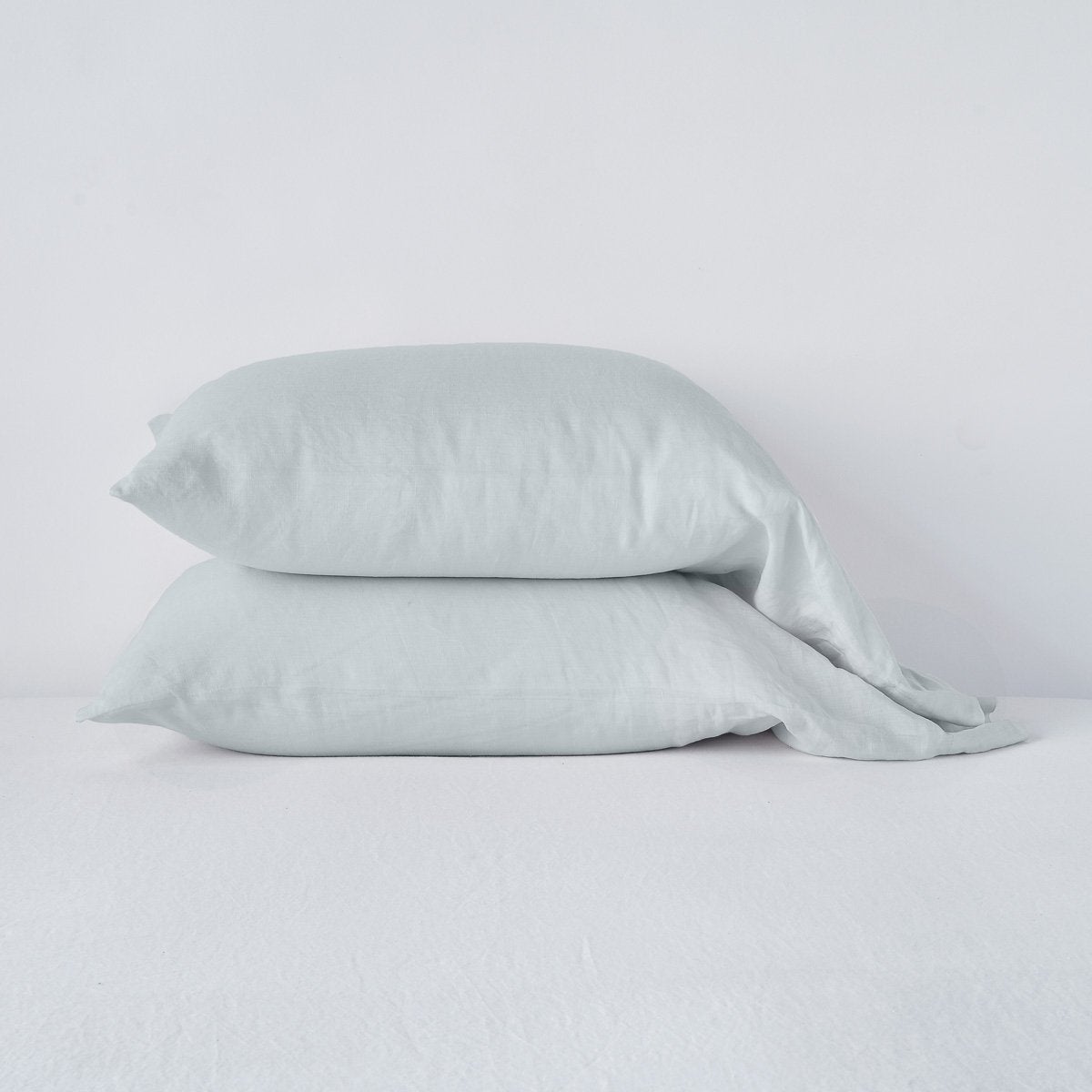 Two stacked Cloud linen pillowcases with relaxed drape against a white background.
