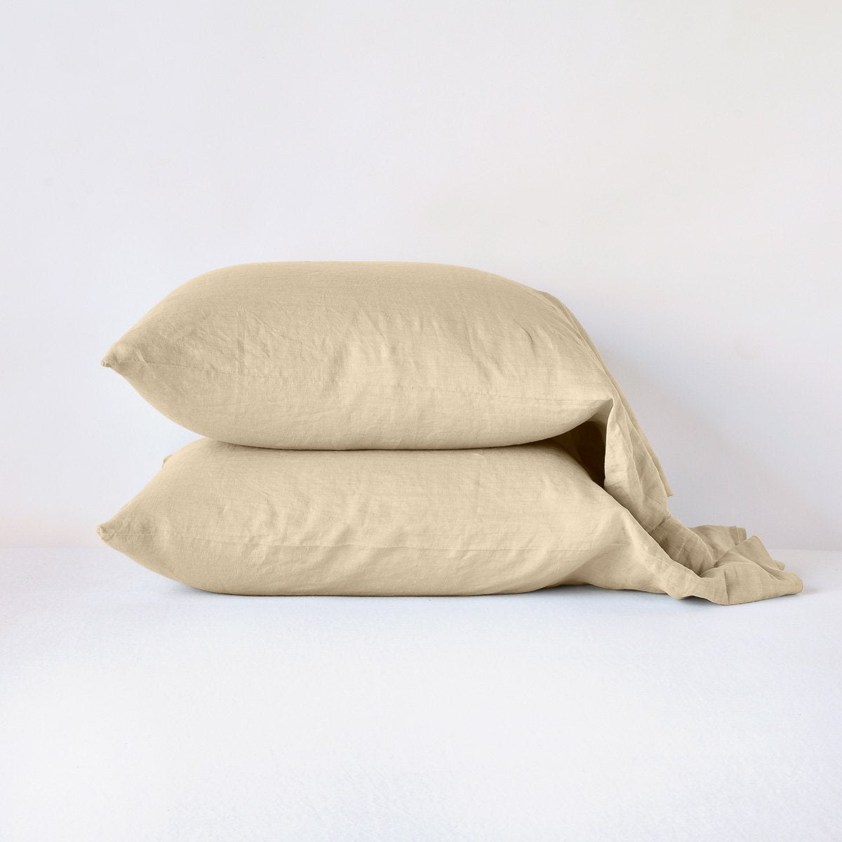 Two Bella Notte Linen pillowcases stacked in Honeycomb, shown on a white surface.