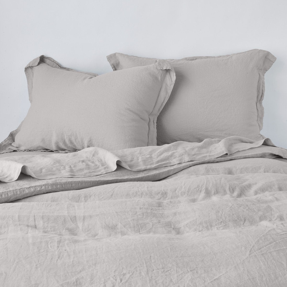 Fog linen euro sham shown with matching duvet, soft relaxed drape and flanged edge detail.