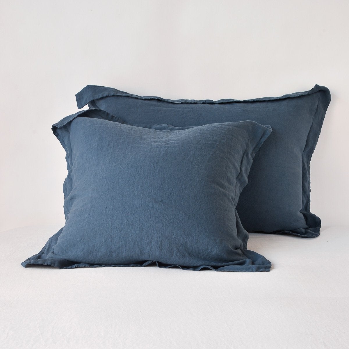 Two Midnight linen shams with frayed ruffle trim, stacked against a white background.